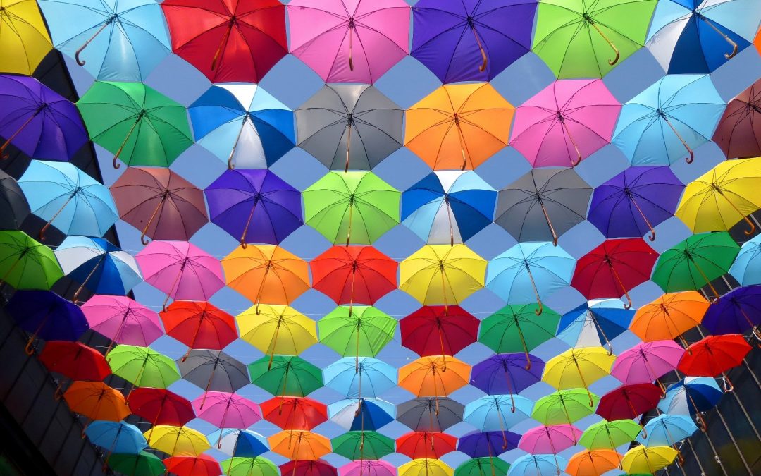 An array of brightly coloured umbrellas hung together to illustrate integration